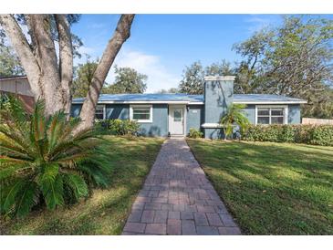 Cute ranch home with brick walkway, mature trees, and a well-manicured lawn at 1101 18Th St, Orange City, FL 32763