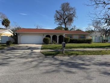 Ranch-style home with attached garage and well-maintained lawn at 2341 Brian Ave, South Daytona, FL 32119