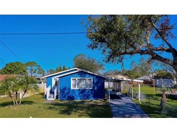 Charming blue house with carport and fenced yard at 420 S Willow Ave, Port Orange, FL 32127