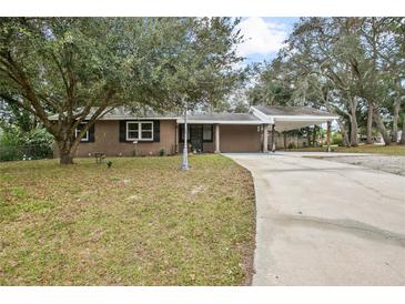 Ranch style home with carport and mature landscaping at 139 Floridana Rd, Debary, FL 32713