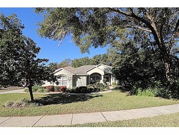 Single-story home with landscaped yard and mature trees at 1525 E Silver Hammock, Deland, FL 32720