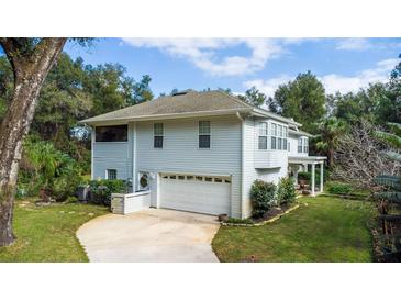 Two-story house with attached garage and landscaped yard at 163 Laurelwood Ln, Ormond Beach, FL 32174