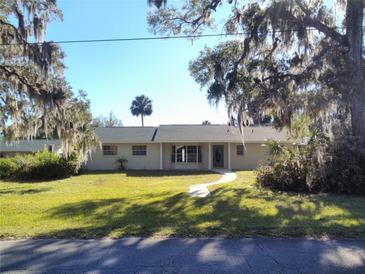 Ranch style home with mature landscaping and a large front yard at 1848 Ridgewood St, Deland, FL 32720