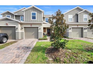 Charming townhome featuring a private garage, covered entry, and manicured lawn in a desirable neighborhood at 2353 Carrabelle Way, Sanford, FL 32771