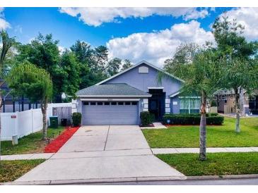 Lovely house with a two-car garage and well-manicured lawn at 2911 Wild Pepper Ave, Deltona, FL 32725