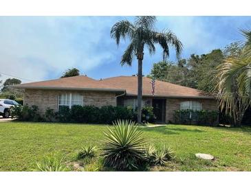 Charming brick home with well-maintained lawn and lovely landscaping at 2994 Annez Way, Debary, FL 32713