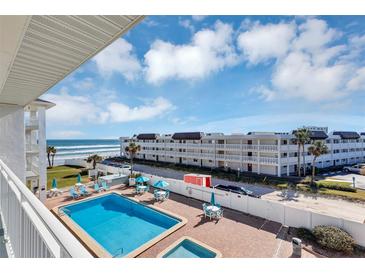 Oceanfront condo complex featuring a refreshing pool; steps to the beach at 3509 S Atlantic Ave # 301, New Smyrna Beach, FL 32169