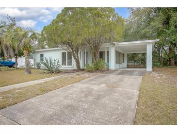 Ranch style home with carport and mature landscaping at 1579 Dunlap Dr, Deltona, FL 32725