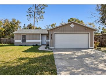 One-story house with attached garage and well-maintained lawn at 1768 Santee Ave, Deltona, FL 32738