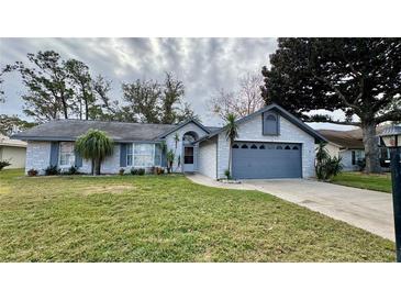 Charming single story home with attached garage and well-maintained lawn at 208 Quaker Ridge Dr, Daytona Beach, FL 32119