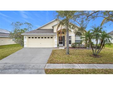 Inviting one-story home with a landscaped lawn and attached garage at 2508 Balmoral Dr, Kissimmee, FL 34744