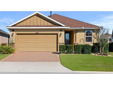 Attractive single-story home with a landscaped lawn and brick driveway at 5579 Nw 40Th Pl, Ocala, FL 34482