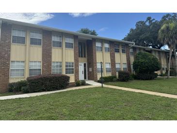 Brick building with entrance and landscaping at 701 Perkins St # 100, Leesburg, FL 34748