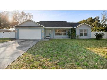 Single-story home with attached garage and well-maintained lawn at 2888 Berkshire Woods Ter, Deltona, FL 32725