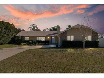 Attractive single-story house with sunset in the background at 373 Blythville Ave, Deltona, FL 32725