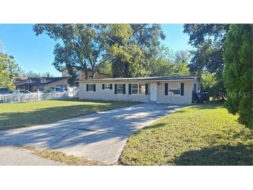 Ranch-style home with a spacious yard and driveway at 5108 Cassatt Ave, Orlando, FL 32808