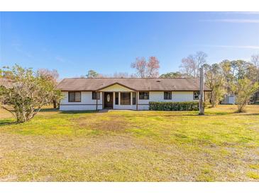 Single-story home with brown trim and a spacious lawn at 601 Rasley Rd, New Smyrna Beach, FL 32168