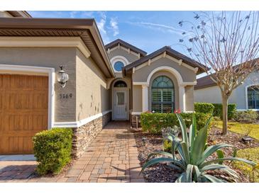 Front entry with a walkway, landscaping, and architectural details at 3169 Connemara Dr, Ormond Beach, FL 32174