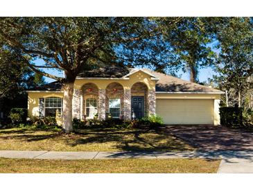 House exterior featuring stone accents and a two-car garage at 101 Los Arbor Dr, Deland, FL 32724