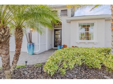 Inviting home exterior with a landscaped front yard, paver driveway, and attractive entryway at 1137 Avery Meadows Way, Deland, FL 32724