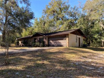 Ranch-style home with attached garage and large yard at 1525 S Hayden Rd, Deland, FL 32724