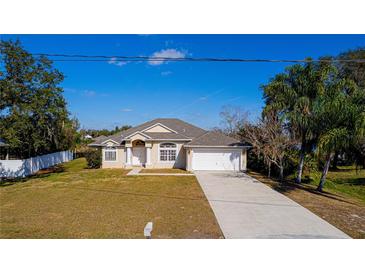 Single-story house with a landscaped lawn, driveway, and attached garage at 2370 Alton Rd, Deltona, FL 32738