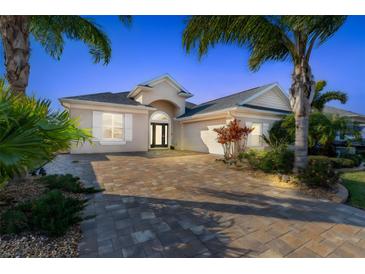 Attractive single-story home with a paved driveway and landscaping at 238 Venetian Palms Blvd, New Smyrna Beach, FL 32168