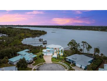 Luxury waterfront home with circular driveway and stunning sunset views at 2806 Bay Vista Ct, New Smyrna Beach, FL 32168