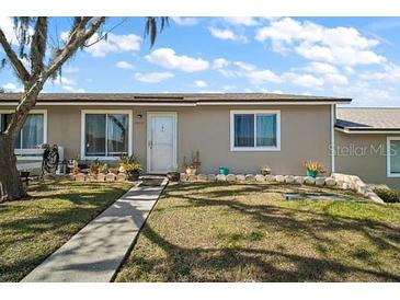 Charming single-story home with a well-maintained front yard and walkway at 30215 Tavares Ridge Blvd # 11, Tavares, FL 32778