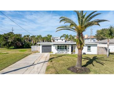 Charming single story home with a gray garage door and white exterior at 333 Boylston S Ave, Daytona Beach, FL 32118