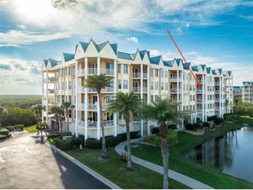 Stunning waterfront condo building featuring manicured grounds, tropical landscaping, and a bright coastal design at 4672 Riverwalk Village # 8406, Ponce Inlet, FL 32127