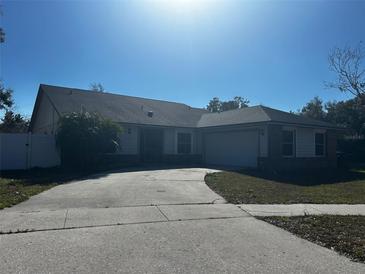 Single-story home with attached two-car garage and driveway at 4942 Eden View Ct, Orlando, FL 32810