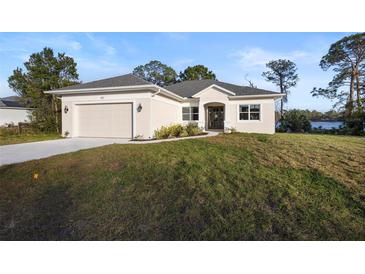 Charming single-story home with a well-manicured lawn and attached two car garage at 177 Rosedale Dr, Deltona, FL 32738