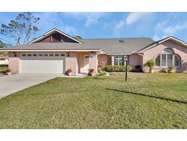 Charming single-story home with a brick facade, well-maintained lawn, and a two-car garage at 2075 Little Farms Ct, Deltona, FL 32738