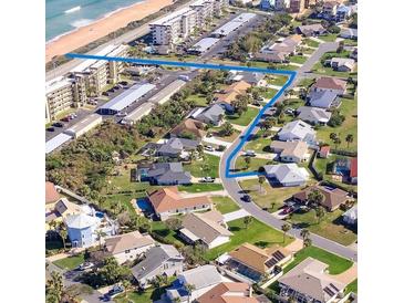 Scenic aerial view of a coastal community with well-maintained homes and convenient beach access along the ocean at 24 Sea Gull Dr, Ormond Beach, FL 32176