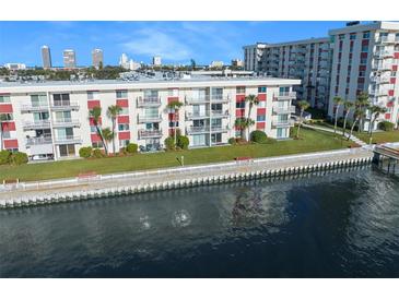 Waterfront condo building with lush landscaping, dock, and city skyline views at 2711 N Halifax Ave # 463, Daytona Beach, FL 32118