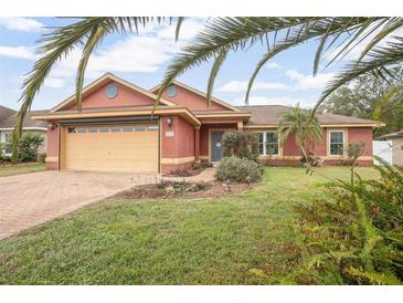 Charming single-story home with a well-maintained lawn and a two-car garage at 35909 Joewood Ave, Leesburg, FL 34788