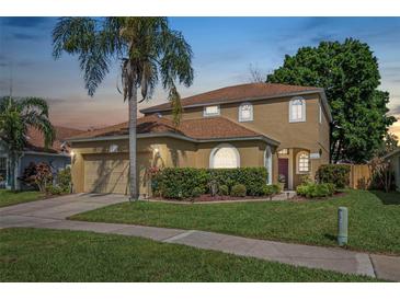 Charming two-story home with well-maintained lawn, mature landscaping, and inviting curb appeal at 3633 Sickle St, Orlando, FL 32812
