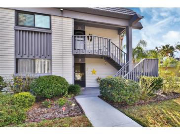 Condo exterior featuring a well-maintained facade, lush landscaping, and inviting entrance at 600 N Boundary Ave # 114B, Deland, FL 32720