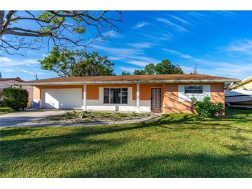 Charming single-story home with a well-manicured lawn and attached two car garage, offering suburban appeal at 1216 Sunland Rd, Daytona Beach, FL 32114
