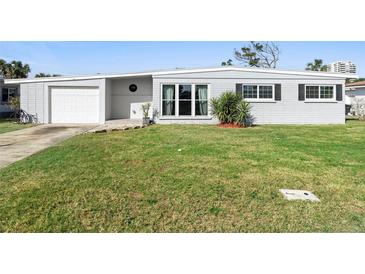 Charming single-story home featuring a well-maintained lawn and an attached one-car garage at 1268 Bel Aire Dr, Daytona Beach, FL 32118