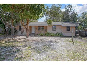 Charming single-story brick home with a cozy front yard and mature trees providing shade at 137 Lucerne Dr, Debary, FL 32713