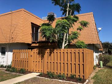 Charming exterior featuring a wooden fence, balcony, and unique roof design at 179 Moonstone Ct, Port Orange, FL 32129