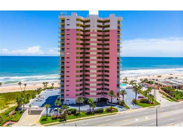 Stunning beachfront condominium with ocean views, a pool, a parking area, and tropical landscaping at 1900 N Atlantic Ave # 901, Daytona Beach, FL 32118