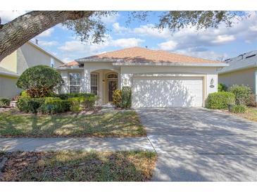 Charming one-story home featuring a two-car garage and lush landscaping at 215 Coleton Ln, Deland, FL 32724