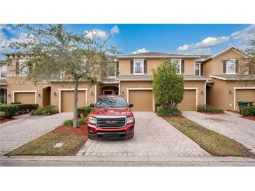 Charming townhouse with brick driveway, one car garage, and well-maintained landscaping at 221 Aston Grande Dr, Daytona Beach, FL 32124