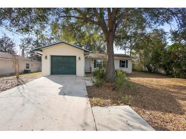 Charming single story home with attached one-car garage, mature trees, and a well-maintained lawn at 370 Charles Ave, Orange City, FL 32763