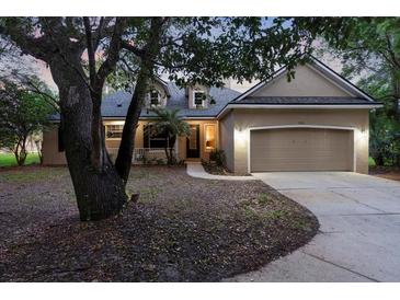 Charming single-Gathering home features a two-car garage, manicured lawn, and a covered porch perfect for relaxing at 725 E New York Ave, Orange City, FL 32763