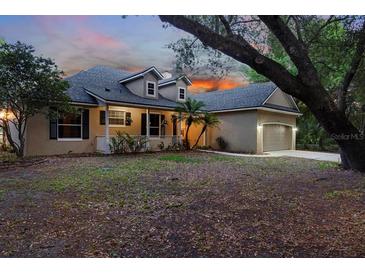Charming two-story home with a welcoming front porch and well-maintained landscaping at 725 E New York Ave, Orange City, FL 32763