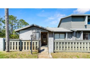 Charming condo featuring a fenced front yard and well-maintained landscaping and front entry at 160 Limewood Pl # 1, Ormond Beach, FL 32174